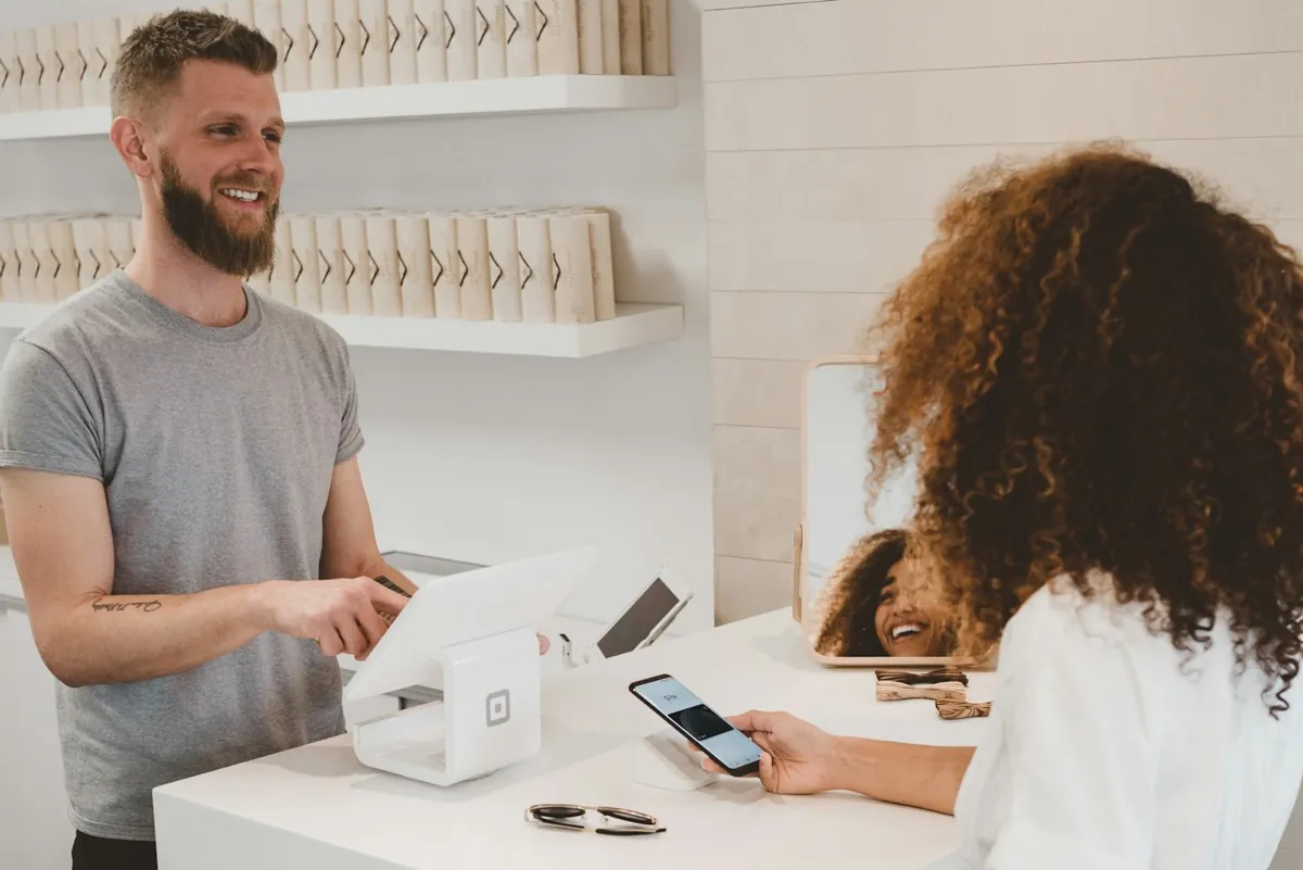 A customer paying at a store counter with a card.