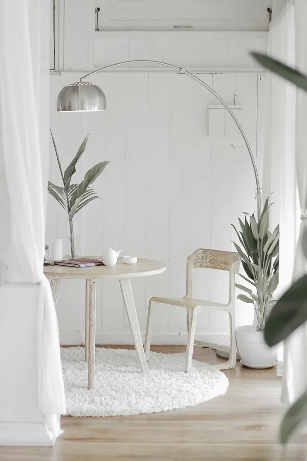 A softly lit, quiet reading chair at night.